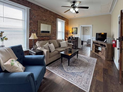 Another view of the inviting living room, highlighting the rug and coffee table.