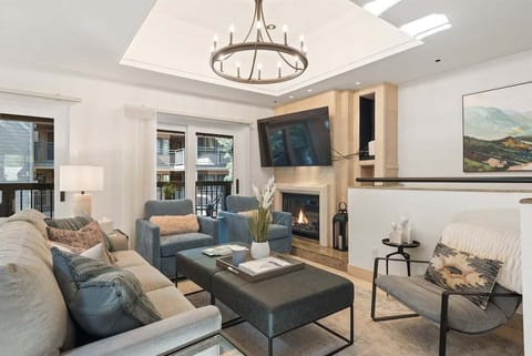 Main floor featuring an open concept kitchen, living, and dining area with wood-burning fireplace and private porch.