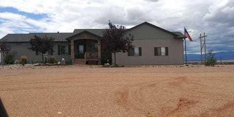 The front of the house with driveways on either side to the back Airbnb unit