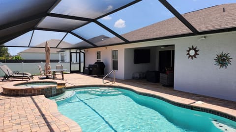 Backyard features pool, spa, bbq, umbrella, lounge chairs, dining table & chairs