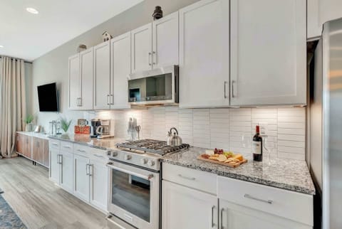 Discover this chic kitchen blending modern elegance with Nashville charm! Perfect for meals with loved ones, this luxurious space boasts sleek finishes and ample room. Enjoy fresh coffee here before exploring Music City!