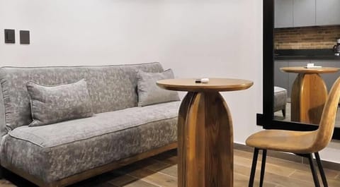 Cozy lounge corner w/ sofa seating, side table & warm lighting—perfect for a quiet break or casual conversation