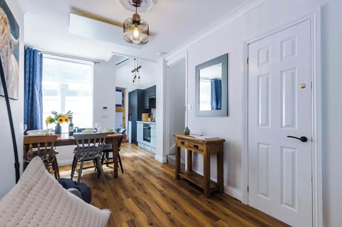 This cosy living room overlooks the charming street below and features a bright blue sofa, smart TV, and ambient mood lighting. With a handpicked selection of books and board games for all ages, it’s the perfect space to unwind and enjoy quality time