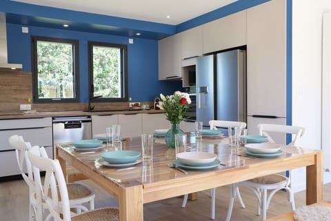 Dining area with large square table seating 8, direct access to terrace