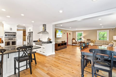 The open-concept Living Area welcomes you with hardwood floors and cozy coastal charm.