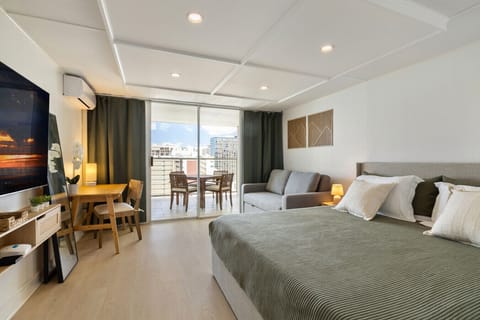 Clean, open space with a comfy king bed, pull-out couch, 65`` smart TV, and functional desk for a simple, modern stay.