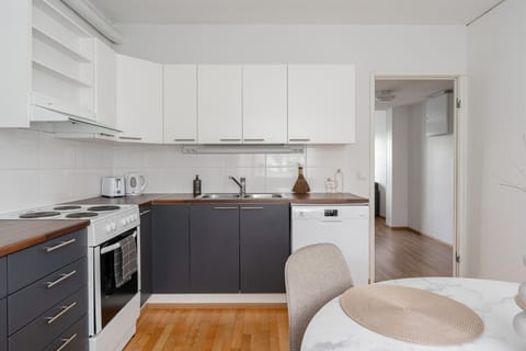 Bright, clean, and functional kitchen stocked with essentials – coffee, spices, and cookware included.