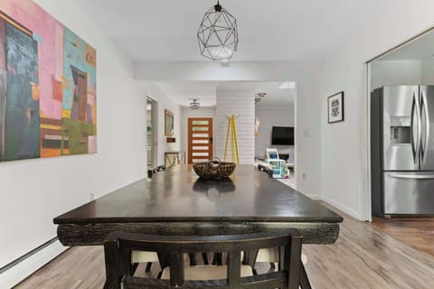 The dining room, with midcentury modern touches invite you to enjoy a meal or play games. 