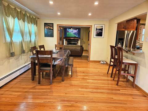 Dining room area, which includes a breakfast bar, facing the kitchen.