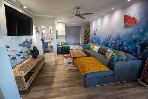 Lounge with extra sofa bed & entrance to bathroom in the back