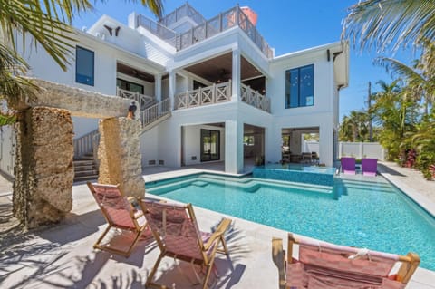 Spacious heated pool with tanning deck and spa