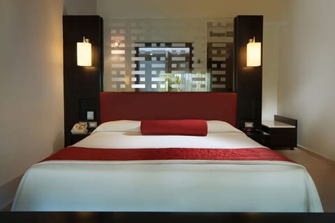 Unwind into plush bedding with warm, romantic ambient lighting.