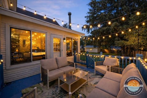 Unwind on the outdoor deck as string lights glow overhead, creating a cozy setting for evening drinks and relaxed conversations. The perfect spot to end the day after exploring the lake or town.