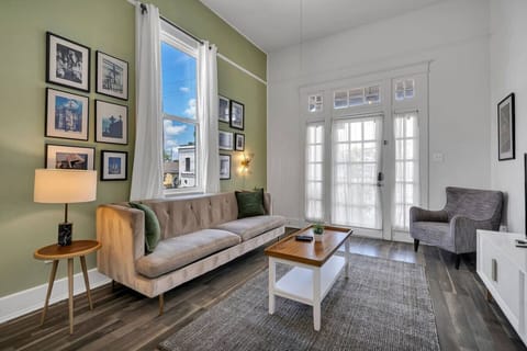 Spacious living room with plenty of seating, natural light, local artwork, and flat-screen TV w/ streaming channels
