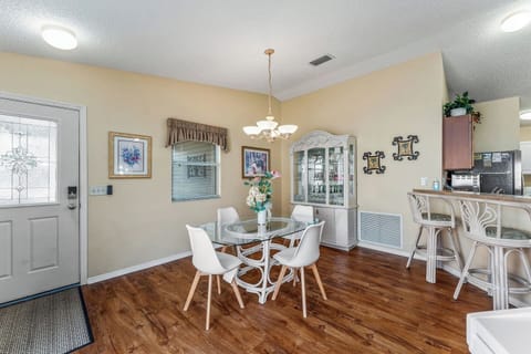 Seating for 4 at the table with two stools for extra guests.