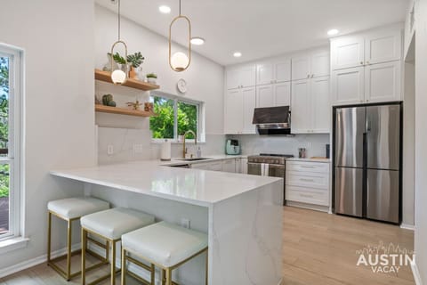 Center island, center stage. Where coffee brews, secrets spill, and stools host quiet café moments.