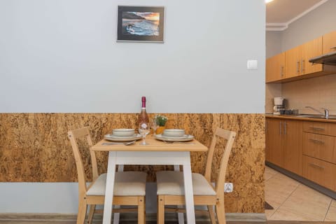 Living space with dining table and chairs, where the guests can enjoy their meals.