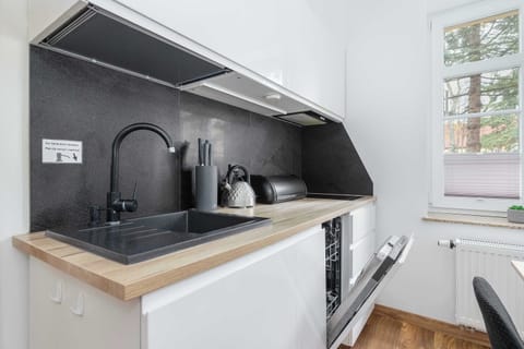 Kitchenette with dishwasher and refrigerator. 