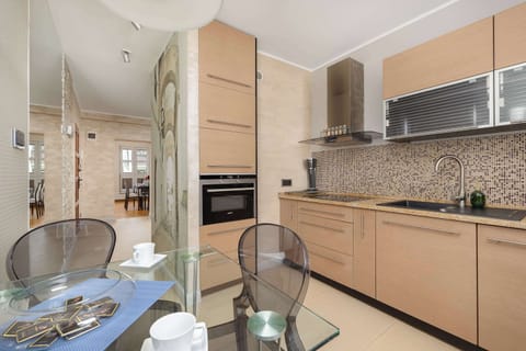 A different perspective of the kitchen, showcasing additional counter space and contemporary design. The warm tones of the cabinetry complement the sleek appliances.