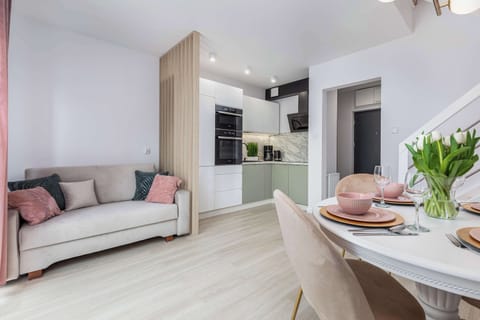 A cosy living room space combined with a kitchenette.