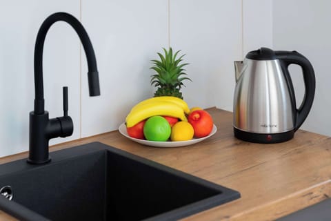 Kitchenette with plenty of kitchen utensils and dishes. 