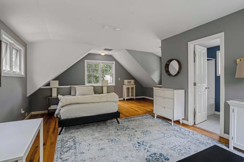 Cozy area with queen bed, desk, and sofa