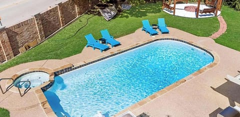 Private pool and kiddie pool with relaxing outdoor lounge area.