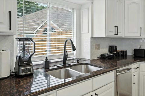 Clean, modern kitchen with tons of counter space, dishwasher, and essentials provided. Ideal for longer stays or family meals.