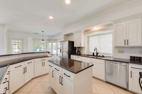 Fully equipped kitchen with granite countertops, island, and stainless appliances. Spacious and ready for home-cooked meals or takeout nights.