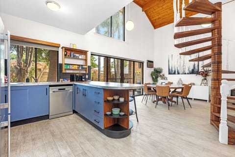 Open living and kitchen area with sit up island bench 