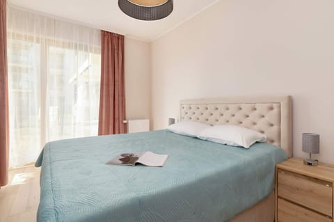 A cosy bedroom in bright colours with a comfortable double bed.