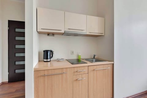 A practical kitchen with warm wood cabinetry and modern appliances.