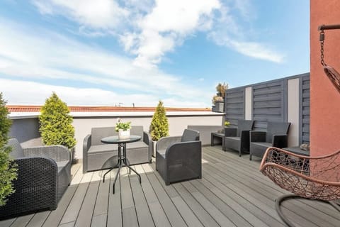 A stunning outdoor terrace with modern patio furniture, providing an excellent space for relaxation or hosting guests.
