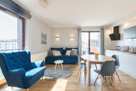 Vibrant, cozy atmosphere with striking blue furniture, sleek, modern decor, and a spacious, airy layout, making it an inviting and stylish retreat.