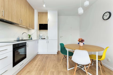 Modern kitchen with a dining table for four, equipped with everything needed for cooking and socializing.