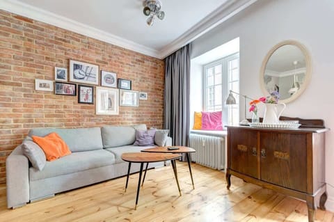  A spacious living room with a comfortable sofa bed, armchairs, and a dining table