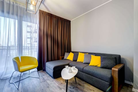 Relax in the stylish living room with a comfortable sofa and modern decor.