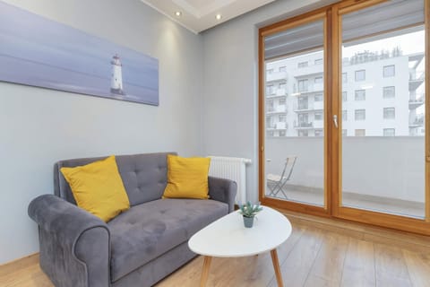 A closer look at the corner of the living room, showcasing large windows and natural light.