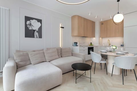 Stylish open-concept area combining the living room, dining space, and kitchen.