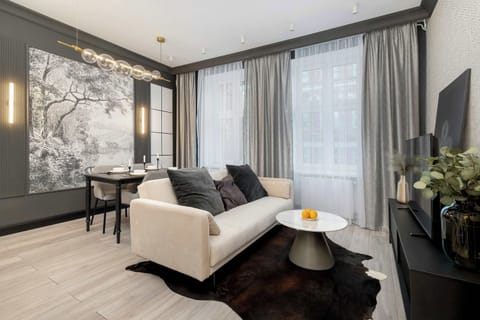 Relax in the stylish living room with a comfortable sofa and modern decor.