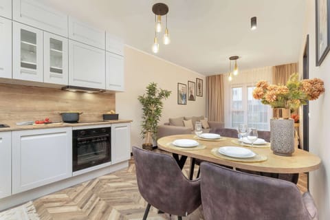 A dining table set for two, featuring plates, glasses, and an elegant centerpiece.