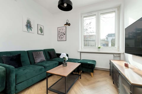 Large windows fill the living space with light, creating a warm and welcoming atmosphere.