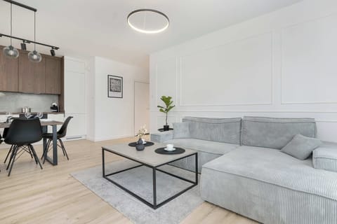 Living room with a corner sofa bed, TV, kitchenette and access to the balcony.