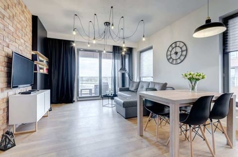 A spacious living room decorated in a modern style, with a comfortable sofa and accessories, creates the perfect place to relax.