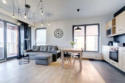 An elegant living room integrated with a functional kitchenette offers space for relaxing and spending time together.