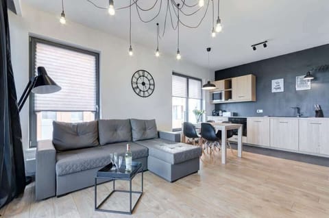 A spacious living room decorated in a modern style, with a comfortable sofa and accessories, creates the perfect place to relax.