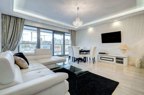 Elegant living room with modern white furnishings, plush black carpet, and stunning ceiling design perfect for luxurious relaxation.