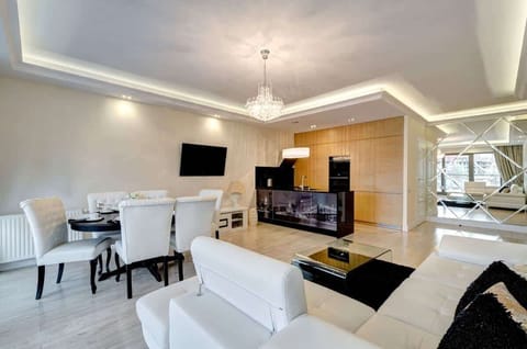 Versatile living space combining entertainment and dining areas with high-end finishes.