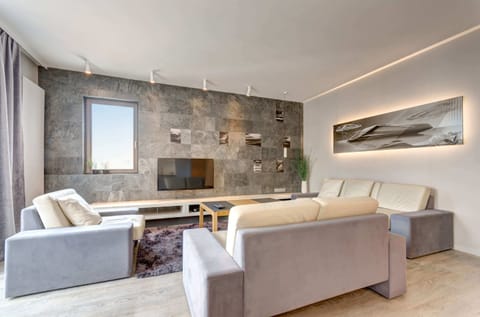 Spacious living room with a decorative media wall. 