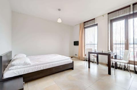The bedroom has a large bed and modern decor. It’s bright and spacious, providing a comfortable place to relax. Perfect for two people.